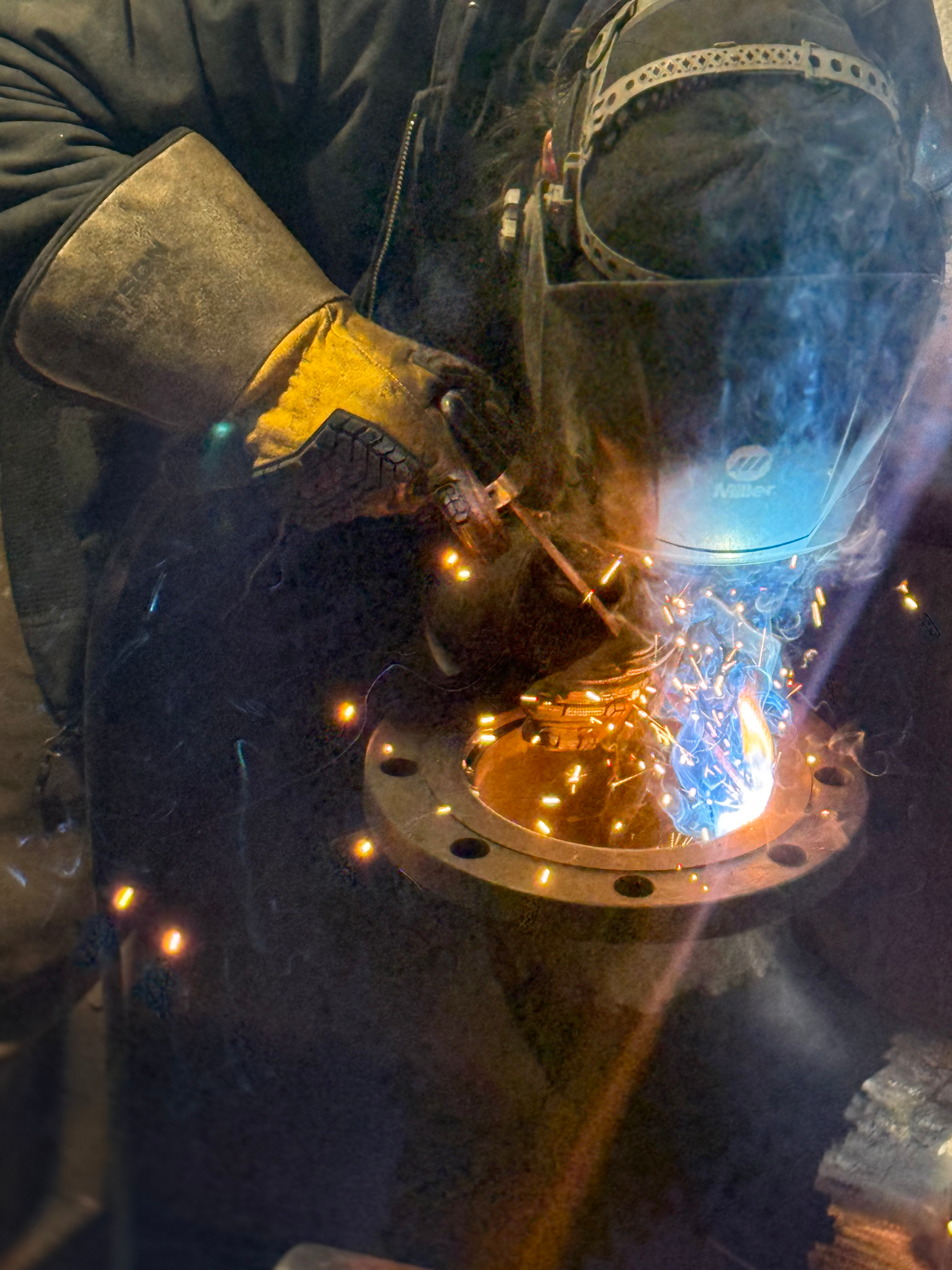 Close-up MIG and TIG welding sparks on steel